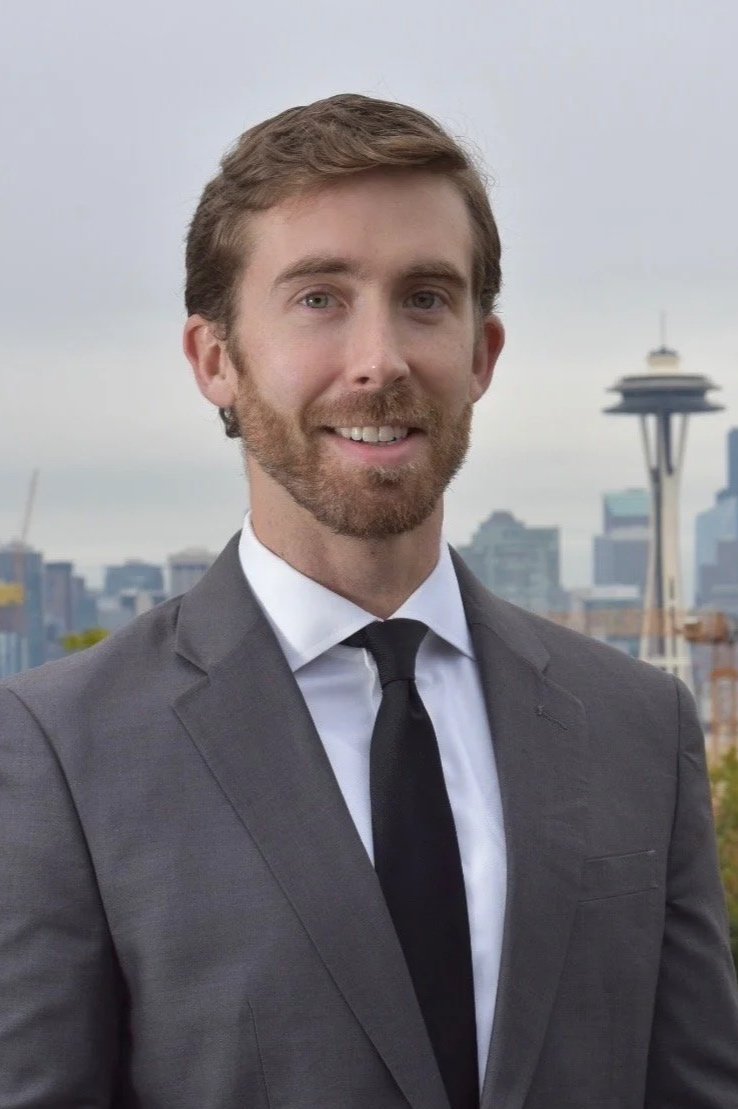 Rob Gillette, mediator, photographed before the Seattle skyline